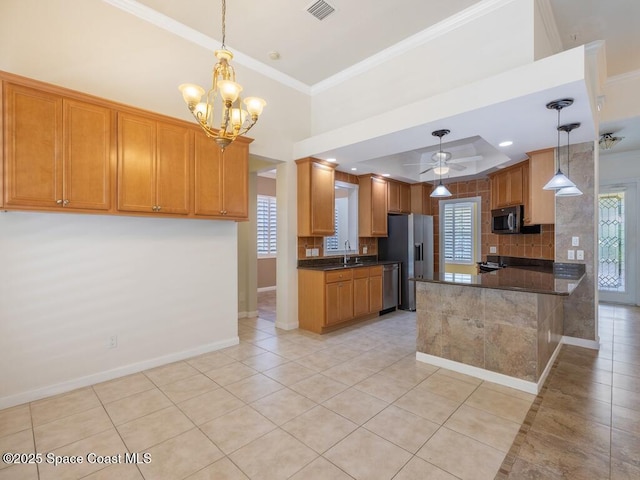 5422 Barbados Sq, Vero Beach, FL 32967 - kitchen featuring appliances with stainless steel finishes, light tile patterned flooring, a chandelier, crown molding, and healthy amount of natural light