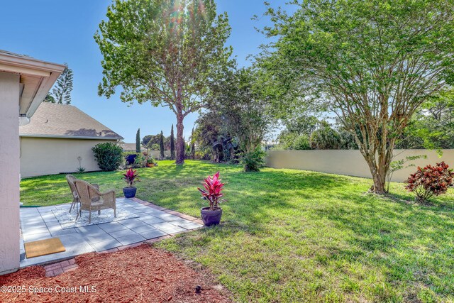 1020 S Fork Cir, Melbourne, FL 32901 - fenced backyard with a patio area