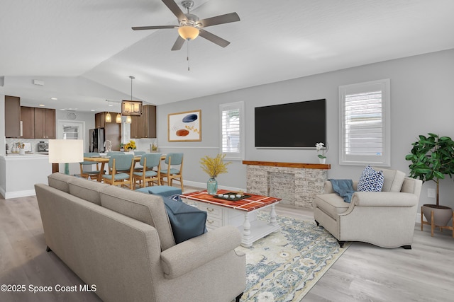 1020 S Fork Cir, Melbourne, FL 32901 - living area with light wood-style flooring, a ceiling fan, and vaulted ceiling