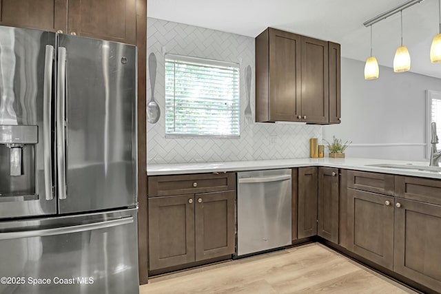 1020 S Fork Cir, Melbourne, FL 32901 - kitchen featuring appliances with stainless steel finishes, decorative backsplash, light countertops, and dark brown cabinetry