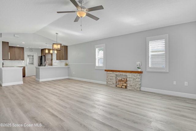 1020 S Fork Cir, Melbourne, FL 32901 - unfurnished living room with vaulted ceiling, light wood finished floors, and ceiling fan