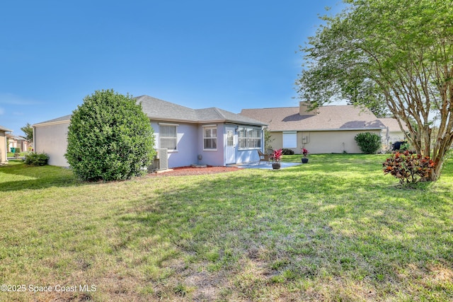 1020 S Fork Cir, Melbourne, FL 32901 - rear view of property featuring a yard, stucco siding, and a patio