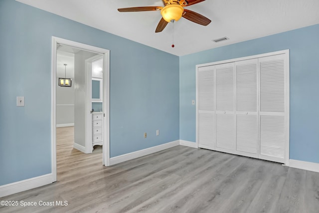 1020 S Fork Cir, Melbourne, FL 32901 - unfurnished bedroom with wood finished floors, a closet, and ceiling fan