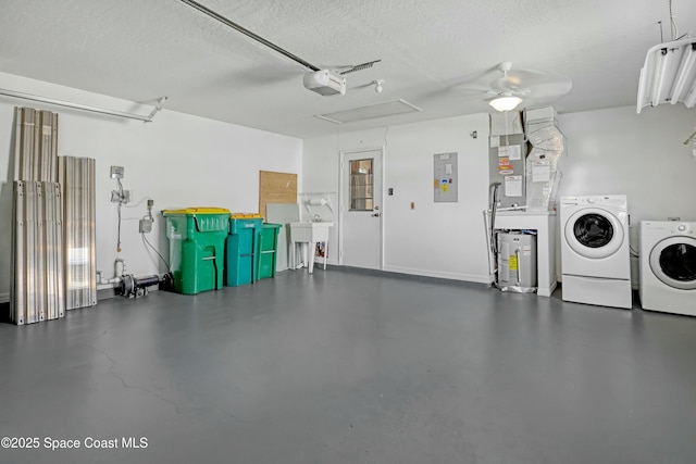 1020 S Fork Cir, Melbourne, FL 32901 - garage featuring washer and clothes dryer, electric panel, a garage door opener, a ceiling fan, and water heater