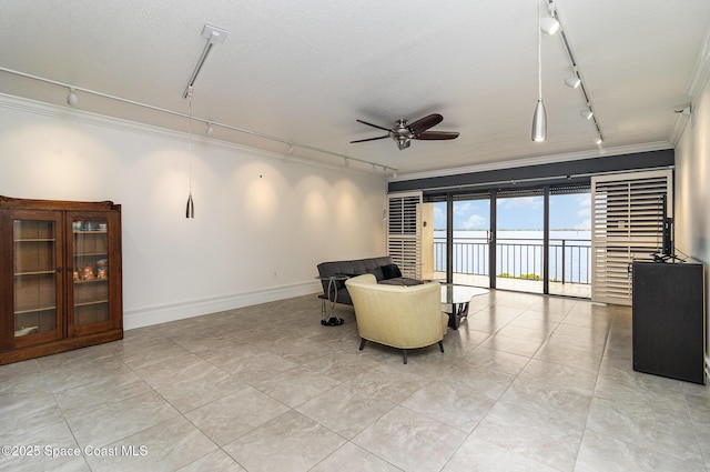 2260 Front St Unit 103, Melbourne, FL 32901 - living room featuring track lighting, ornamental molding, ceiling fan, baseboards, and light tile patterned floors