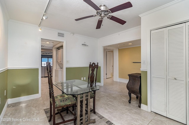 2260 Front St Unit 103, Melbourne, FL 32901 - dining area featuring crown molding, a ceiling fan, light tile patterned floors, track lighting, and baseboards