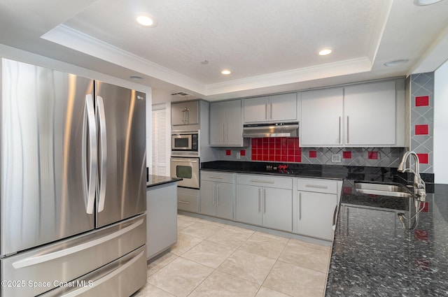 2260 Front St Unit 103, Melbourne, FL 32901 - kitchen with appliances with stainless steel finishes, a sink, a raised ceiling, gray cabinetry, and ornamental molding