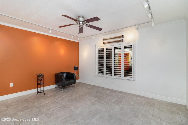 2260 Front St Unit 103, Melbourne, FL 32901 - unfurnished room featuring rail lighting, a ceiling fan, ornamental molding, baseboards, and a textured ceiling