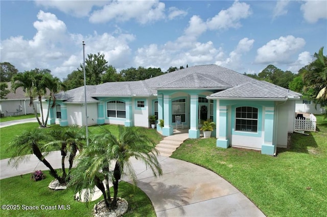 1641 Galilean Ln, Sebastian, FL 32958 - view of front of property with covered porch, a front yard, stucco siding, roof with shingles, and driveway