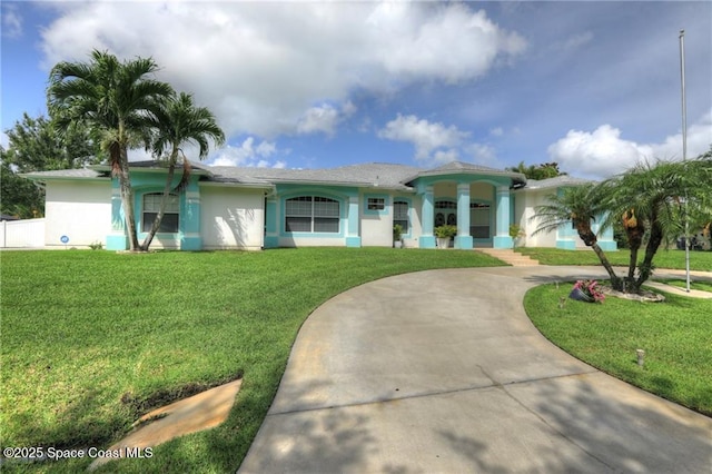 1641 Galilean Ln, Sebastian, FL 32958 - single story home featuring curved driveway, stucco siding, and a front lawn