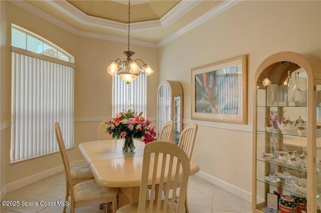 1641 Galilean Ln, Sebastian, FL 32958 - dining area featuring tile patterned flooring, a chandelier, crown molding, baseboards, and a raised ceiling