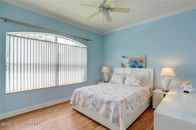 1641 Galilean Ln, Sebastian, FL 32958 - bedroom with multiple windows, wood finished floors, crown molding, baseboards, and a ceiling fan