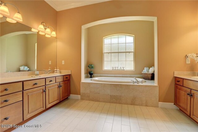 1641 Galilean Ln, Sebastian, FL 32958 - full bathroom with two vanities, a bath, and baseboards