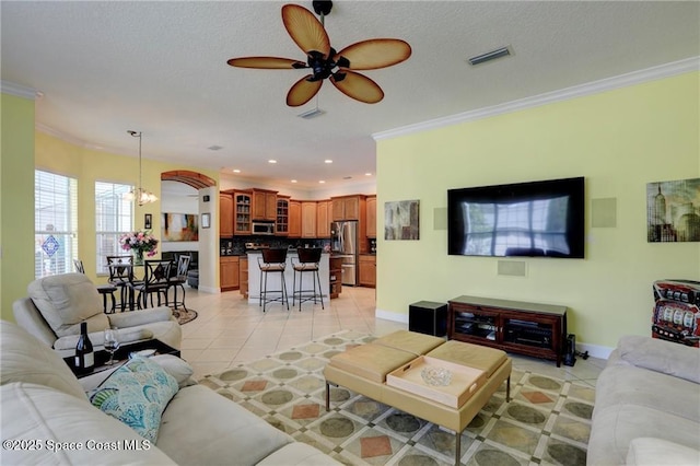 1641 Galilean Ln, Sebastian, FL 32958 - living room featuring light tile patterned floors, ornamental molding, a ceiling fan, a chandelier, and baseboards