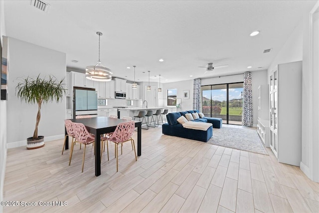 7917 Dobre Way, Melbourne, FL 32940 - dining space featuring recessed lighting, light wood finished floors, ceiling fan, and a chandelier