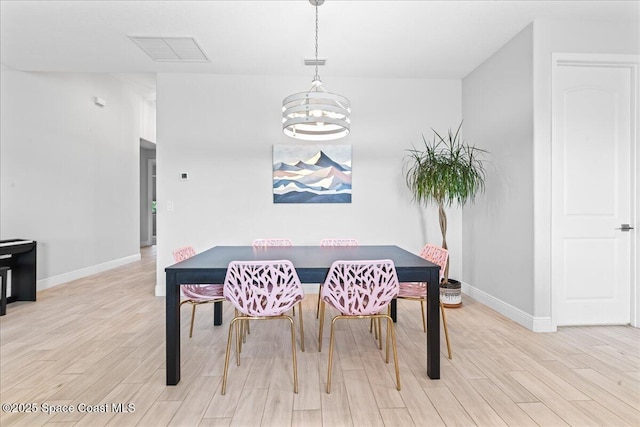 7917 Dobre Way, Melbourne, FL 32940 - dining space with a chandelier, light wood-style floors, and baseboards