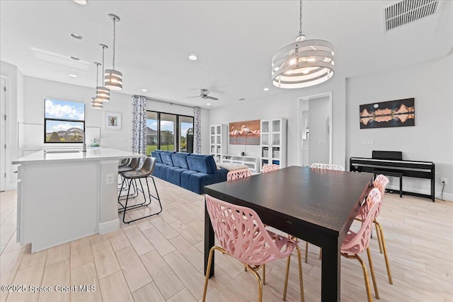 7917 Dobre Way, Melbourne, FL 32940 - dining room with recessed lighting, a chandelier, a ceiling fan, and light wood finished floors