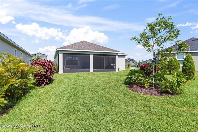 7917 Dobre Way, Melbourne, FL 32940 - rear view of property featuring a sunroom, a yard, roof with shingles, and stucco siding