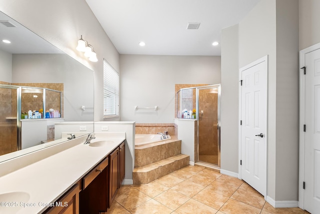 125 Rudy St, Auburndale, FL 33823 - bathroom featuring a garden tub, double vanity, a shower stall, tile patterned floors, and recessed lighting