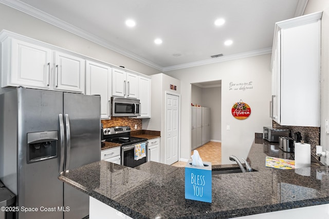 125 Rudy St, Auburndale, FL 33823 - kitchen with stainless steel appliances, recessed lighting, white cabinets, decorative backsplash, and crown molding