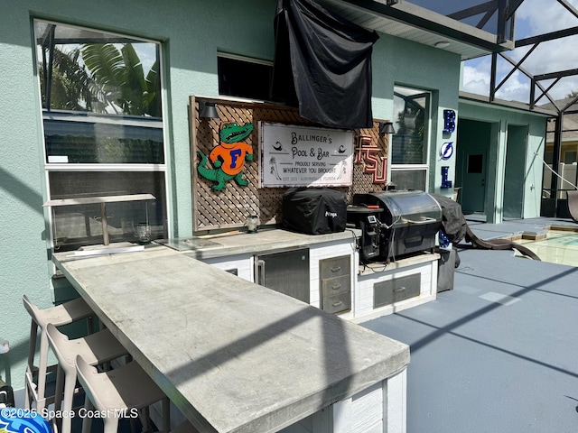 125 Rudy St, Auburndale, FL 33823 - view of patio / terrace featuring exterior kitchen and a lanai