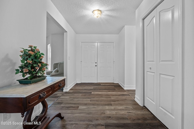 3435 Felda St, Cocoa, FL 32926 - entryway featuring a textured ceiling, dark wood-style floors, and baseboards