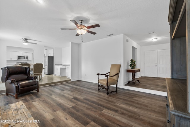 3435 Felda St, Cocoa, FL 32926 - living area with ceiling fan, dark wood-type flooring, baseboards, and a textured ceiling