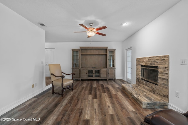 3435 Felda St, Cocoa, FL 32926 - living area with a ceiling fan, dark wood-style floors, baseboards, and a fireplace