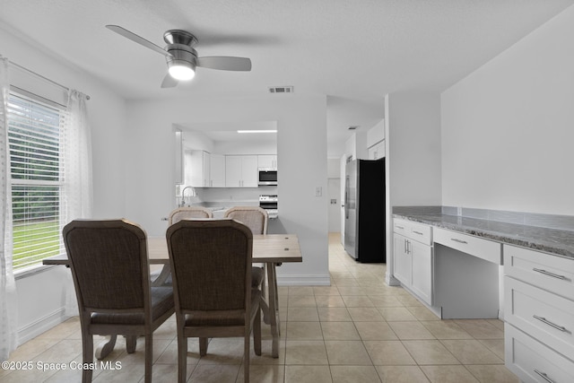 3435 Felda St, Cocoa, FL 32926 - dining room with ceiling fan, plenty of natural light, light tile patterned floors, and baseboards