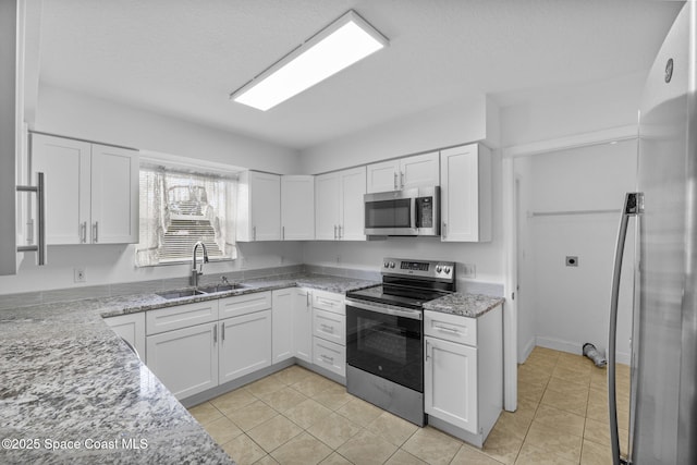 3435 Felda St, Cocoa, FL 32926 - kitchen with stainless steel appliances, a sink, white cabinets, and light stone countertops