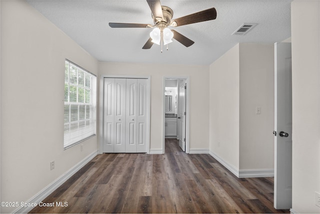 3435 Felda St, Cocoa, FL 32926 - unfurnished bedroom featuring wood finished floors, baseboards, a closet, a textured ceiling, and a ceiling fan