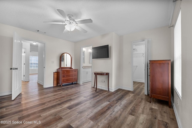 3435 Felda St, Cocoa, FL 32926 - bedroom with wood finished floors, a walk in closet, baseboards, and ensuite bath
