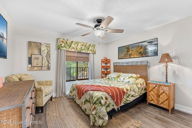 200 International Dr Unit 817, Cape Canaveral, FL 32920 - bedroom featuring wood finished floors, baseboards, a textured ceiling, and ceiling fan