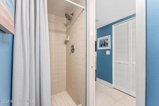 200 International Dr Unit 817, Cape Canaveral, FL 32920 - bathroom featuring a shower stall, tile patterned flooring, and a closet