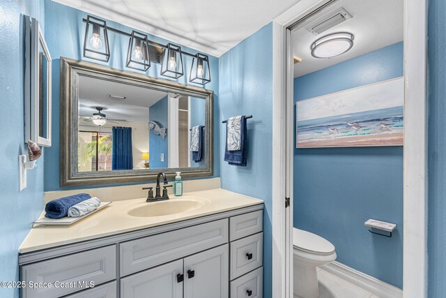 200 International Dr Unit 817, Cape Canaveral, FL 32920 - bathroom featuring vanity, toilet, ceiling fan, and baseboards