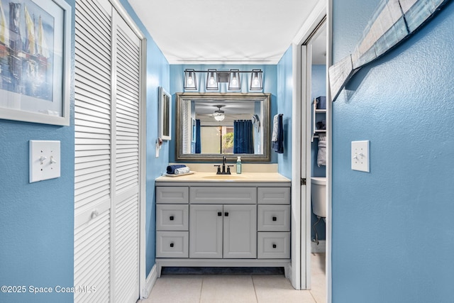 200 International Dr Unit 817, Cape Canaveral, FL 32920 - bathroom with a closet, tile patterned flooring, toilet, vanity, and a textured wall