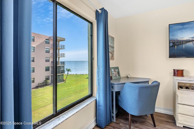 200 International Dr Unit 817, Cape Canaveral, FL 32920 - office area with baseboards, wood finished floors, and built in desk