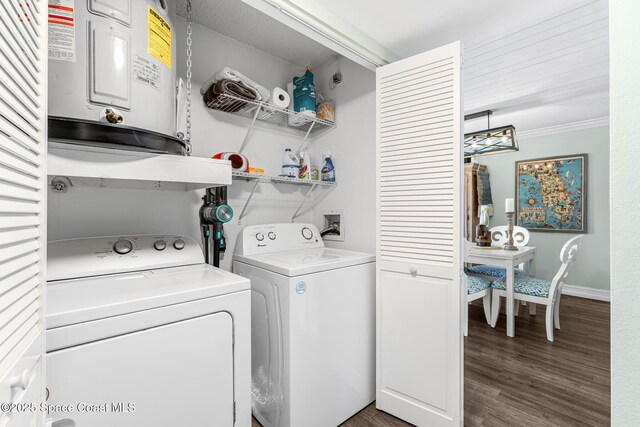 200 International Dr Unit 817, Cape Canaveral, FL 32920 - washroom featuring independent washer and dryer, wood finished floors, ornamental molding, and baseboards
