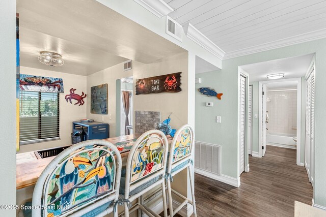 200 International Dr Unit 817, Cape Canaveral, FL 32920 - dining room featuring baseboards, wood finished floors, and crown molding