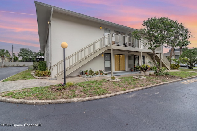 1935 Conway Rd Unit A4, Orlando, FL 32812 - view of front of property with stairway, stucco siding, and a deck