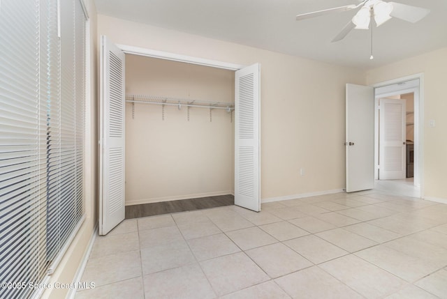1935 Conway Rd Unit A4, Orlando, FL 32812 - unfurnished bedroom with a closet, light tile patterned flooring, ceiling fan, and baseboards