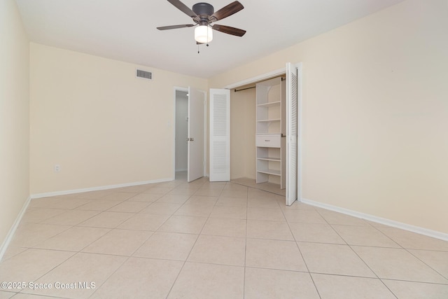 1935 Conway Rd Unit A4, Orlando, FL 32812 - unfurnished bedroom featuring baseboards, light tile patterned flooring, a closet, and a ceiling fan