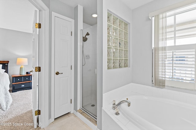 5201 Ocean Beach Blvd Unit 4, Cocoa Beach, FL 32931 - full bathroom featuring a bath, a shower stall, connected bathroom, and tile patterned floors