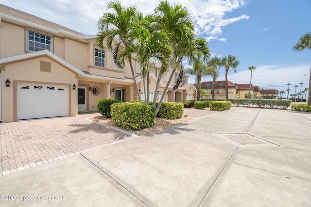 5201 Ocean Beach Blvd Unit 4, Cocoa Beach, FL 32931 - view of front of home featuring decorative driveway and stucco siding