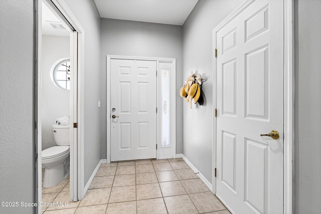 5201 Ocean Beach Blvd Unit 4, Cocoa Beach, FL 32931 - entryway with light tile patterned floors and baseboards