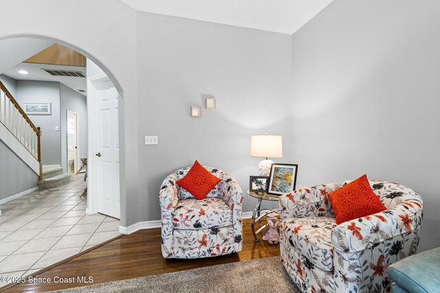 5201 Ocean Beach Blvd Unit 4, Cocoa Beach, FL 32931 - living area with arched walkways, stairway, and recessed lighting