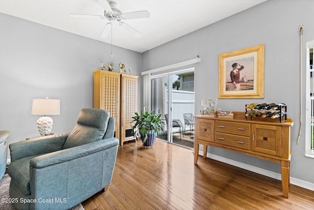 5201 Ocean Beach Blvd Unit 4, Cocoa Beach, FL 32931 - living area with wood finished floors and ceiling fan