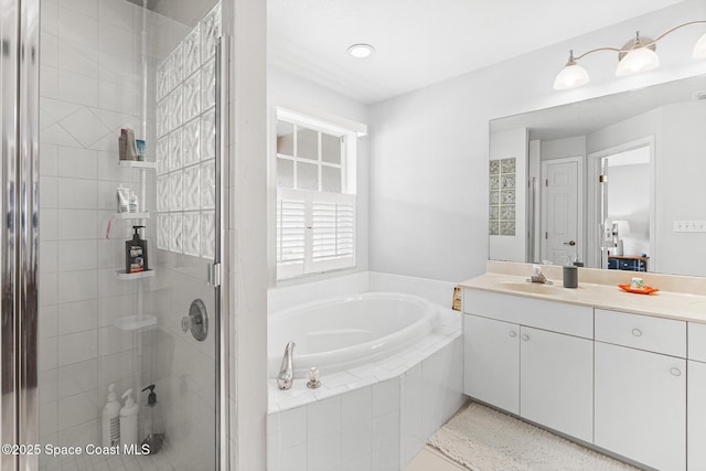 5201 Ocean Beach Blvd Unit 4, Cocoa Beach, FL 32931 - bathroom featuring vanity, a garden tub, and a stall shower
