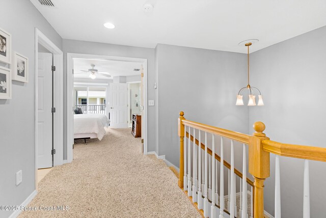 5201 Ocean Beach Blvd Unit 4, Cocoa Beach, FL 32931 - hallway with an upstairs landing, carpet, and a chandelier