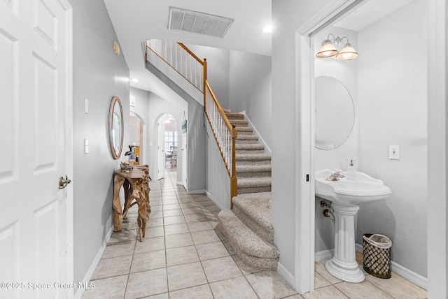 5201 Ocean Beach Blvd Unit 4, Cocoa Beach, FL 32931 - entryway featuring stairway and light tile patterned floors